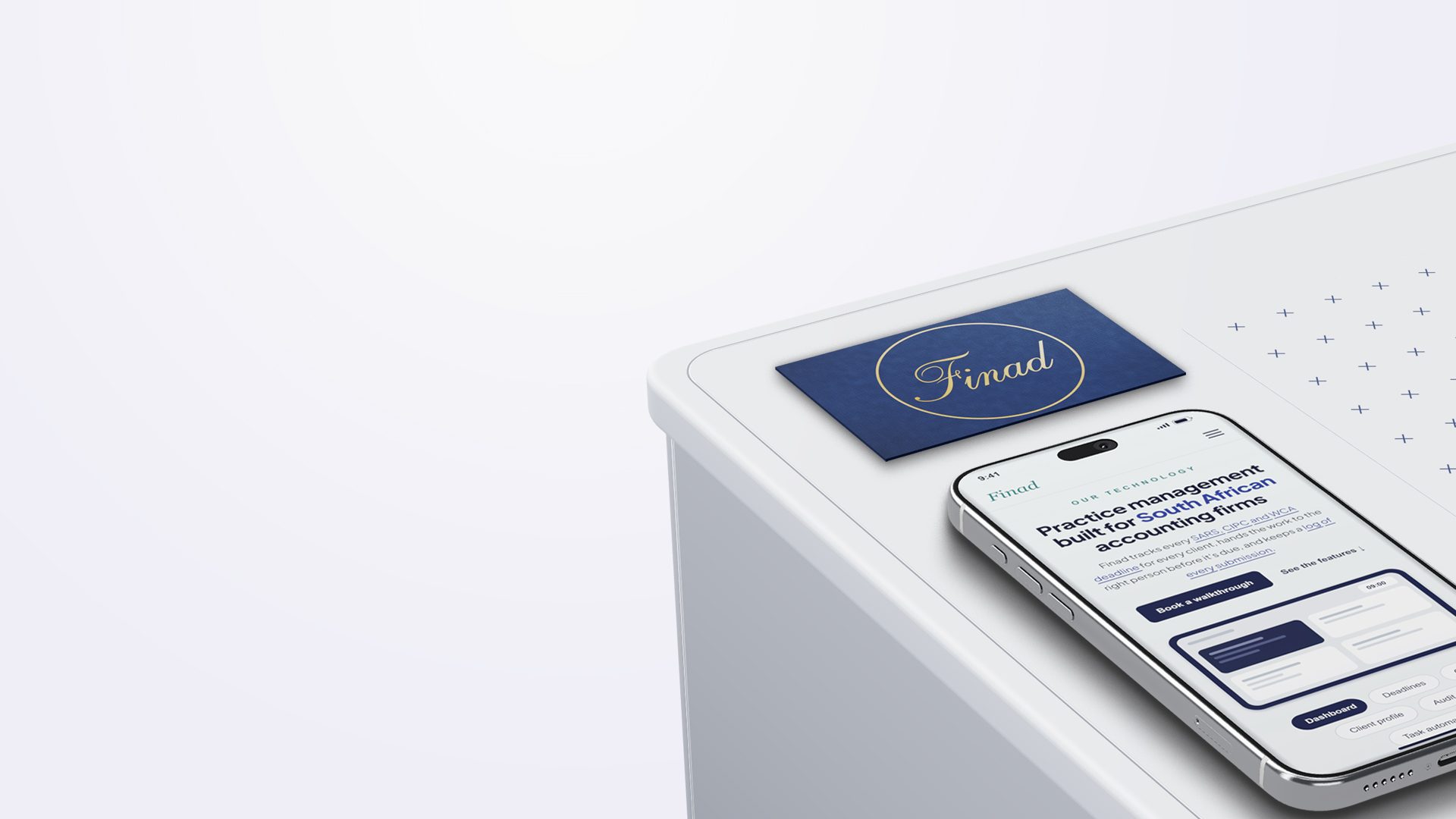 A navy Finad business card beside a phone showing the Finad practice dashboard